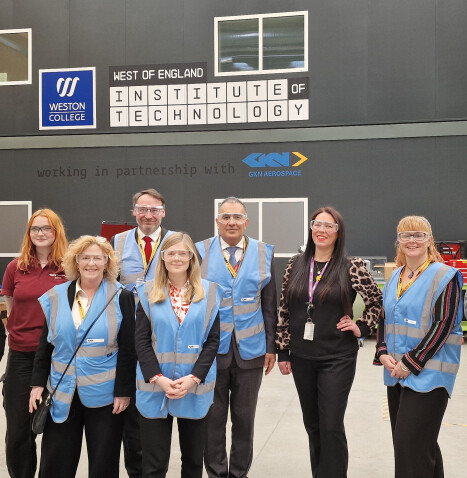 A group of people in protective gear stand outside the West of England Institute of Technology
